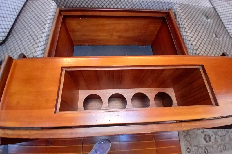 Slide: The Image of Interior of 1983 Wauquiez Hood with wooden furniture and seating area. - 8