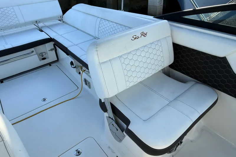 Slide: The Image of 2022 Sea Ray SDX 250 boat interior with white cushioned seating and hexagonal stitching. - 7