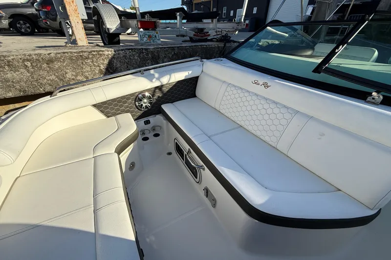 Slide: The Image of 2022 Sea Ray SDX 250 boat interior with white seating and hexagonal pattern design. - 8