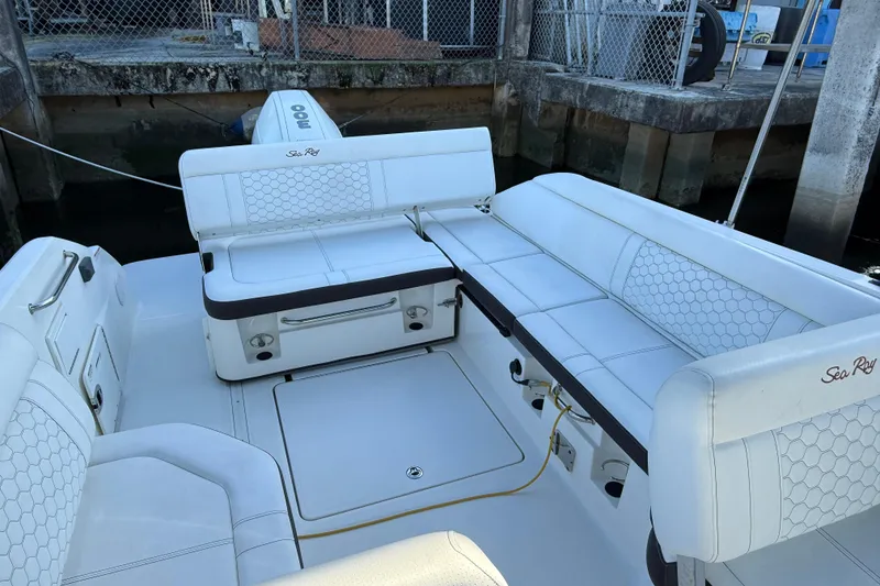 Slide: The Image of 2022 Sea Ray SDX 250 boat interior with white seating and storage compartments. - 9