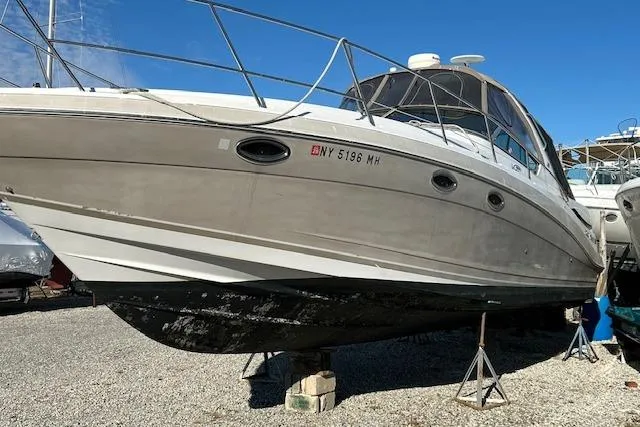 Slide: The Image of 2007 Four Winns 358 Vista boat on stands, displayed outdoors under clear blue sky. - 1