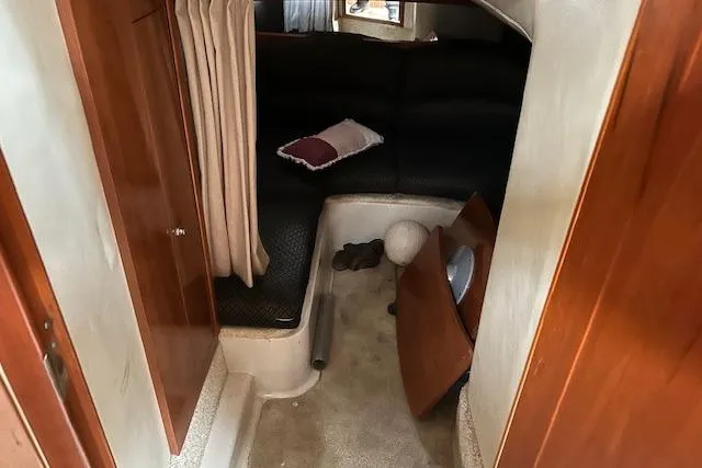 Slide: The Image of 2007 Four Winns 358 Vista cabin interior with seating and curtain. - 11