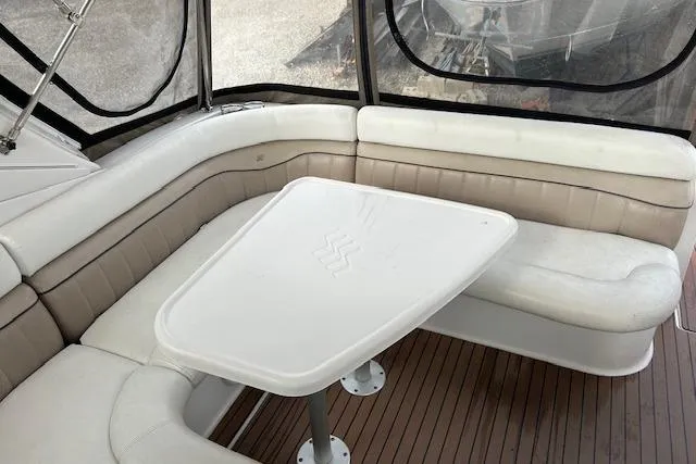 Slide: The Image of 2007 Four Winns 358 Vista boat interior with cushioned seating and table. - 3