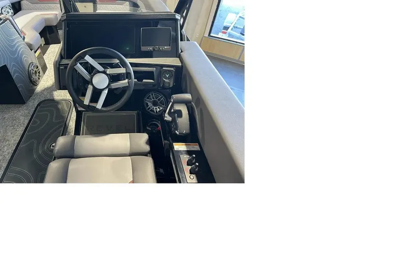 Slide: The Image of 2026 Revel RS25L boat interior with modern steering wheel and dashboard controls. - 2