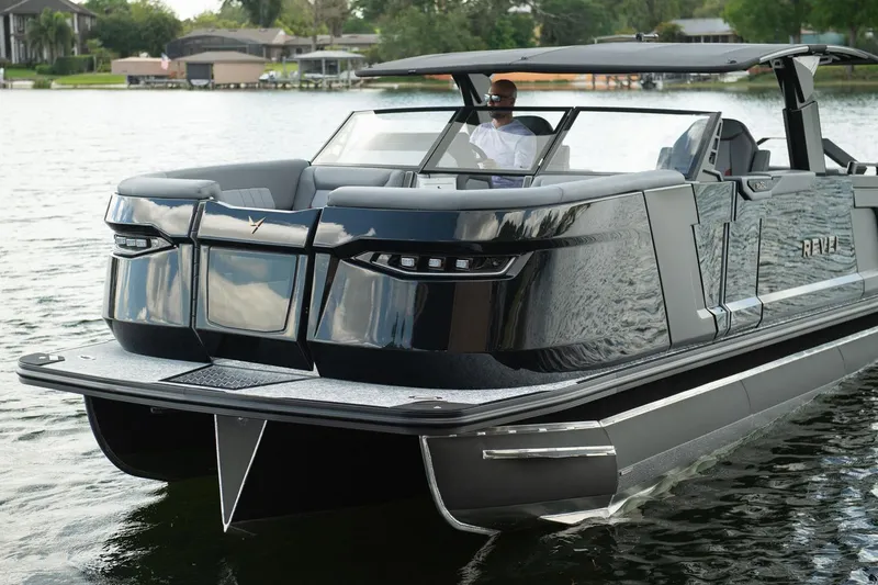 Slide: The Image of Manufacturer Provided Image: 2026 Revel RS25L luxury pontoon boat on a serene lake. - 9