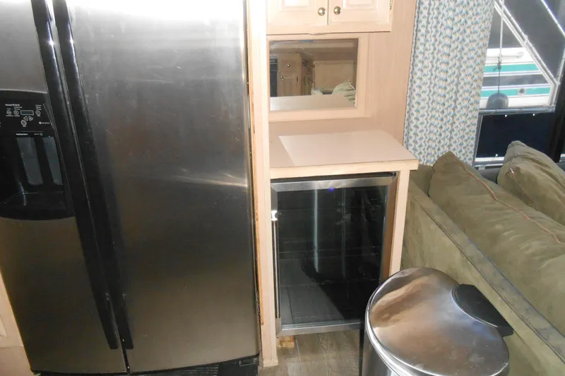 Slide: The Image of Interior of 1991 Stardust Cruisers 7516 with fridge, counter, and sofa. - 12