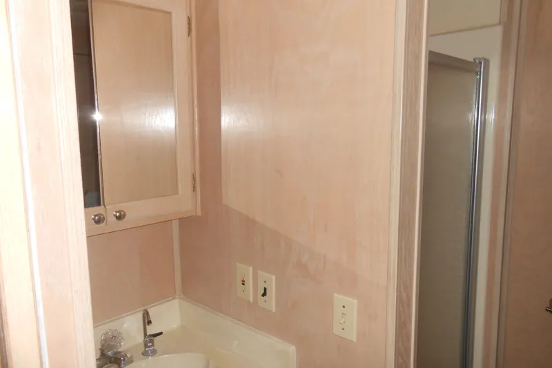 Slide: The Image of Bathroom interior of 1991 Stardust Cruisers 7516 with sink, mirror, and shower. - 15