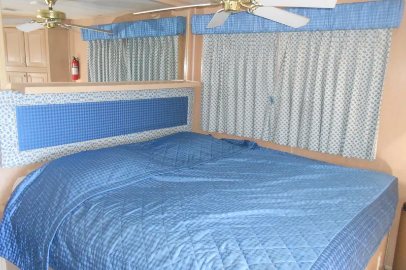 Slide: The Image of Interior of 1991 Stardust Cruisers 7516 with blue bedding and curtains. - 21