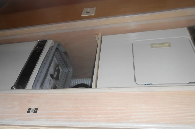 Slide: The Image of Interior view of a 1991 Stardust Cruisers 7516, featuring built-in appliances. - 22