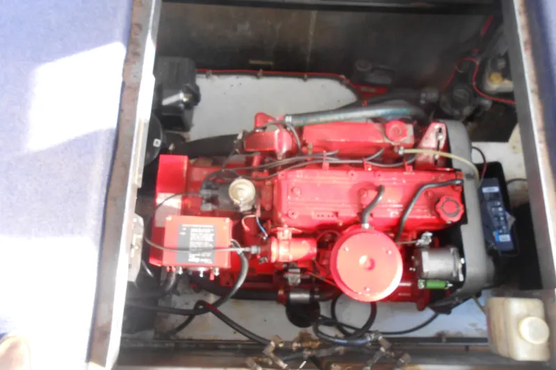 Slide: The Image of Engine compartment of a 1991 Stardust Cruisers 7516, featuring a red engine. - 26