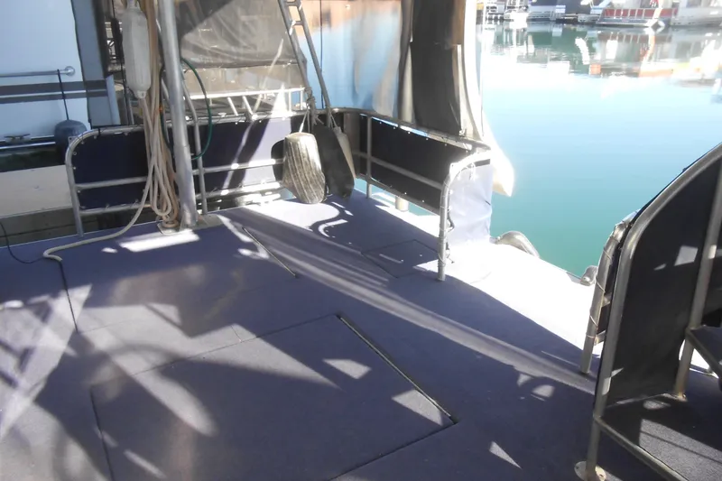 Slide: The Image of 1991 Stardust Cruisers 7516 boat deck with railing and water view. - 28