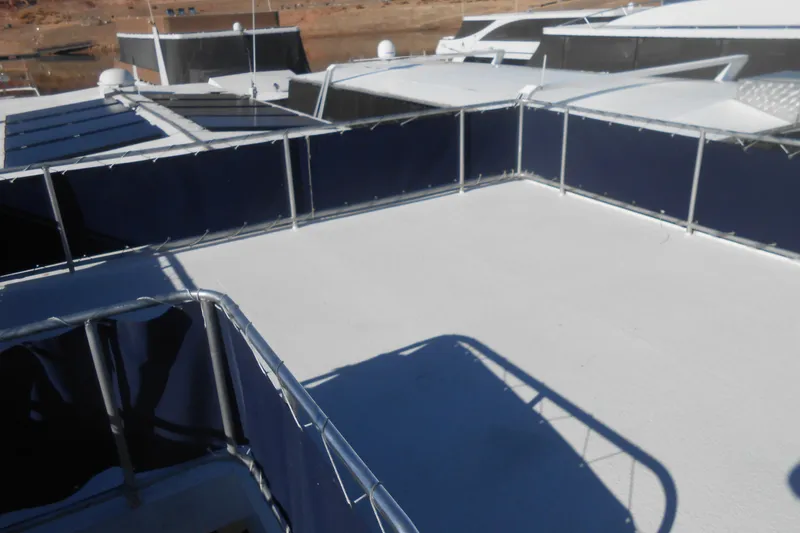 Slide: The Image of Rooftop deck of 1991 Stardust Cruisers 7516 houseboat with blue railings. - 34