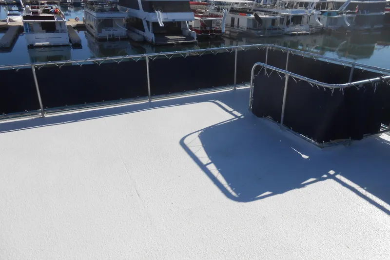 Slide: The Image of Upper deck of a 1991 Stardust Cruisers 7516 houseboat at a marina. - 36
