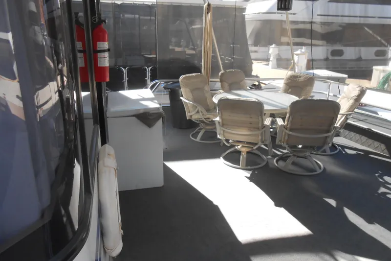 Slide: The Image of 1991 Stardust Cruisers 7516 boat deck with dining area and fire extinguishers. - 37