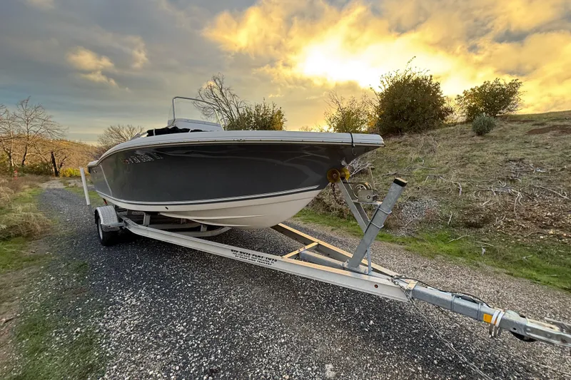 The Image of 2021 Tidewater 198 CC Adventure boat on trailer at sunset. - 0