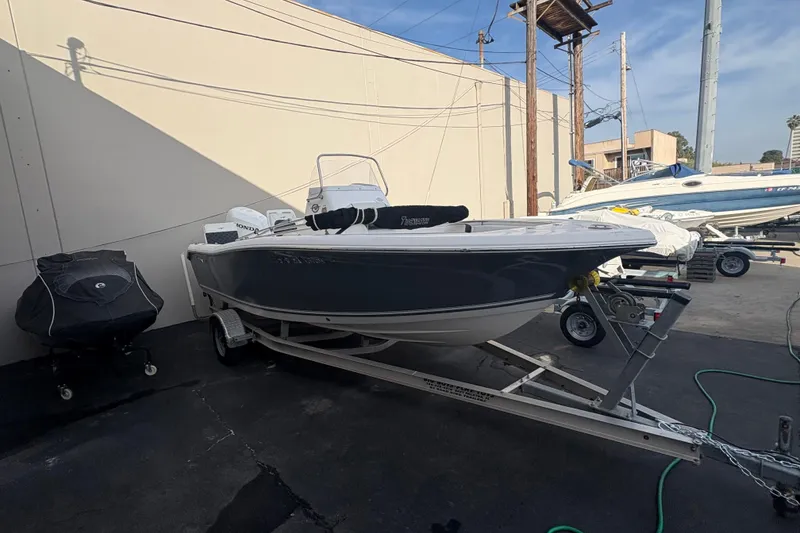 Slide: The Image of 2021 Tidewater 198 CC Adventure boat on trailer in outdoor storage area. - 2