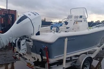 Slide: The Image of 2021 Tidewater 198 CC Adventure boat on trailer with outboard motor, parked outdoors. - 5