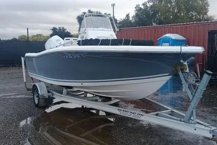 Slide: The Image of 2021 Tidewater 198 CC Adventure boat on trailer, parked outdoors. - 6