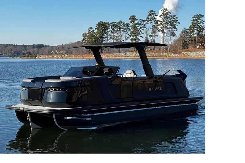 Slide: The Image of 2026 Revel RS25L pontoon boat on a serene lake with trees in the background. - 3