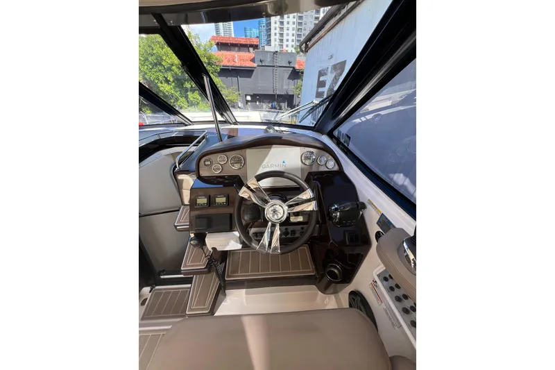 Slide: The Image of Cockpit of 2015 Regal 35 Sport Coupe with steering wheel and control panel. - 14