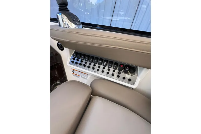 Slide: The Image of Control panel of a 2015 Regal 35 Sport Coupe boat with switches and buttons. - 17