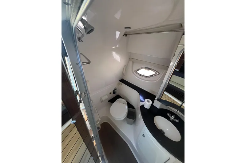 Slide: The Image of Bathroom interior of 2015 Regal 35 Sport Coupe yacht, featuring toilet and sink. - 23