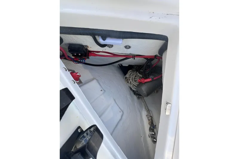 Slide: The Image of 2015 Regal 35 Sport Coupe interior compartment with wiring and rope storage. - 28