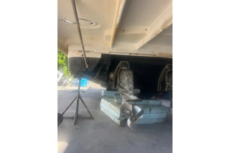 Slide: The Image of 2015 Regal 35 Sport Coupe boat underside with propeller and support stands. - 32