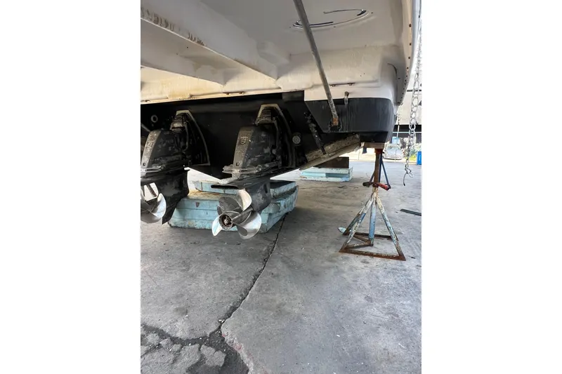 Slide: The Image of 2015 Regal 35 Sport Coupe boat on stands, showing dual propellers. - 34