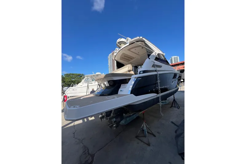 Slide: The Image of 2015 Regal 35 Sport Coupe yacht on dry dock under clear blue sky. - 35