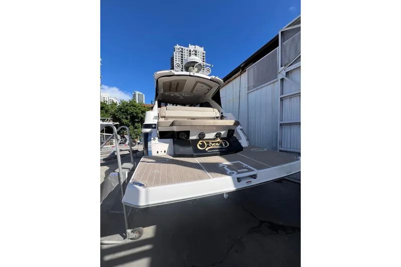 Slide: The Image of 2015 Regal 35 Sport Coupe yacht docked under clear blue sky. - 4