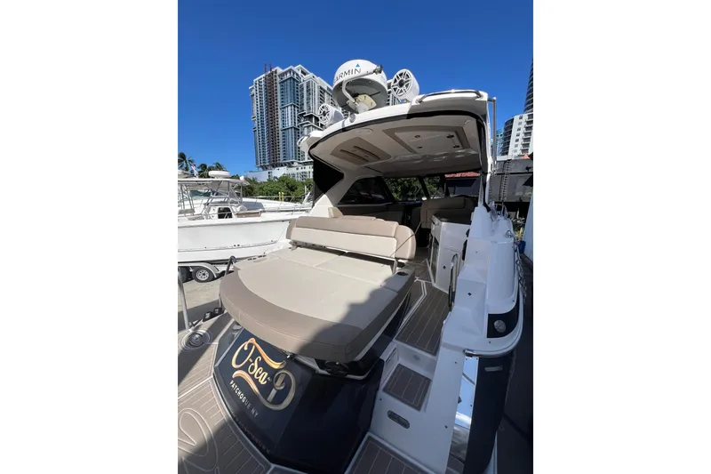 Slide: The Image of 2015 Regal 35 Sport Coupe yacht docked with city skyline backdrop. - 6