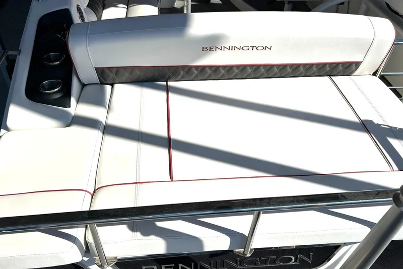 Slide: The Image of 2021 Bennington 25 RXSBA boat interior with white seating and cup holders. - 29
