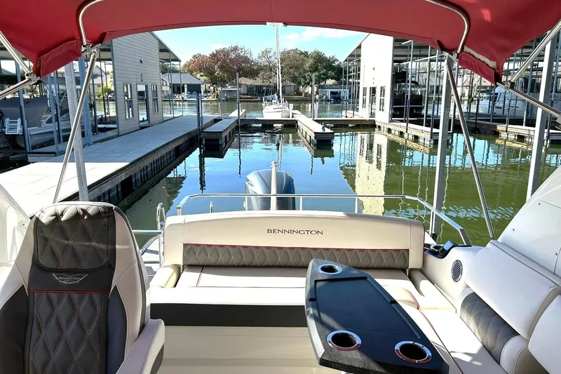 Slide: The Image of 2021 Bennington 25 RXSBA pontoon boat interior at marina dock. - 3