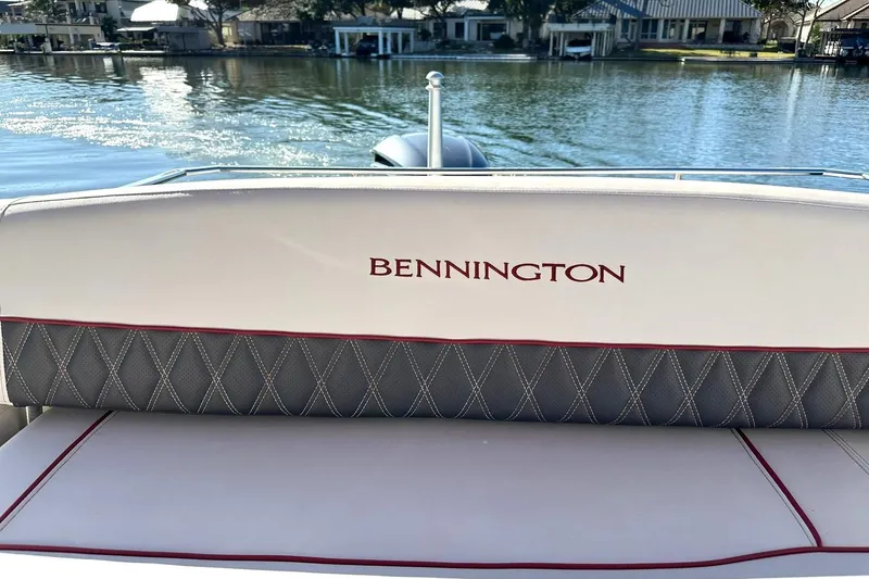 Slide: The Image of 2021 Bennington 25 RXSBA boat interior with logo, lake view in background. - 30