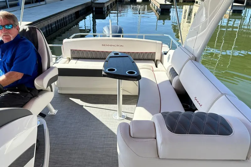 Slide: The Image of 2021 Bennington 25 RXSBA pontoon boat interior with seating and table. - 33
