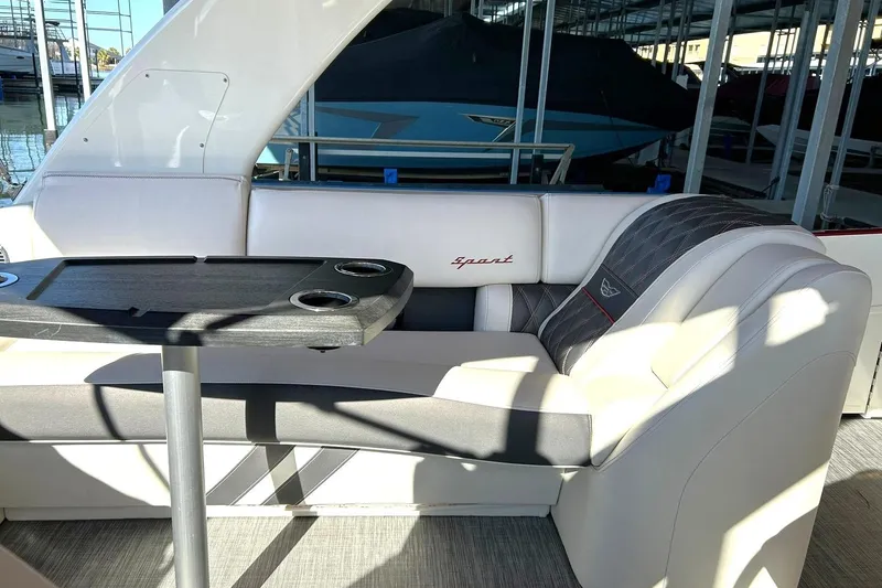Slide: The Image of 2021 Bennington 25 RXSBA boat interior with cushioned seating and table. - 34