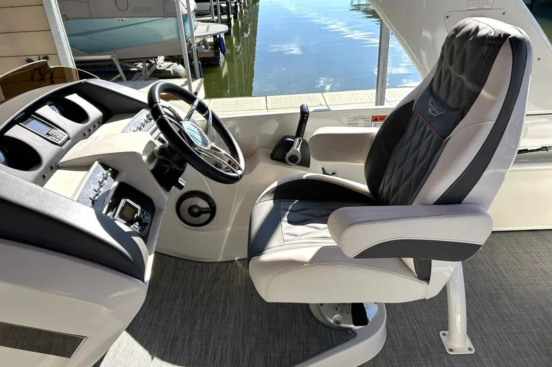 Slide: The Image of Captain's chair and helm of 2021 Bennington 25 RXSBA boat, dockside view. - 38