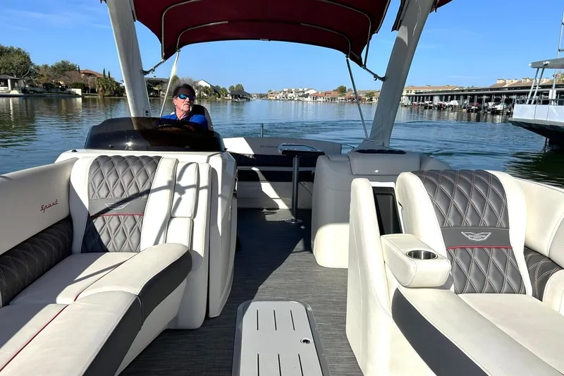 Slide: The Image of 2021 Bennington 25 RXSBA pontoon boat on a scenic waterway. - 43