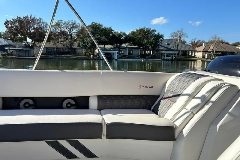 Slide: The Image of 2021 Bennington 25 RXSBA boat interior with luxurious seating by a serene lake. - 44