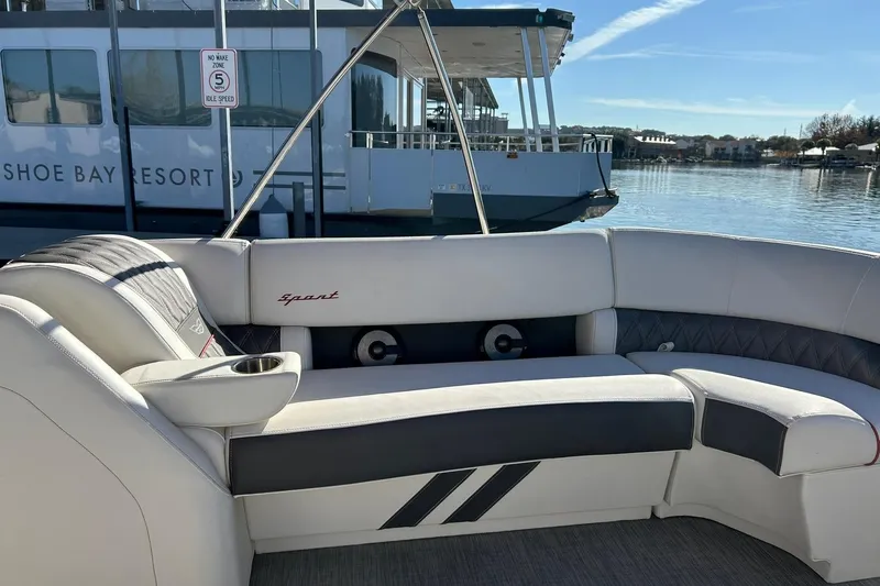 Slide: The Image of 2021 Bennington 25 RXSBA boat interior with luxury seating at a marina. - 46