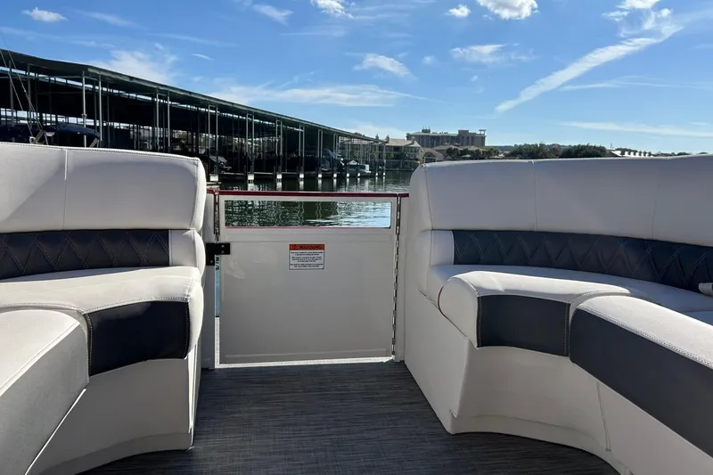Slide: The Image of 2021 Bennington 25 RXSBA boat interior with marina view under blue sky. - 49