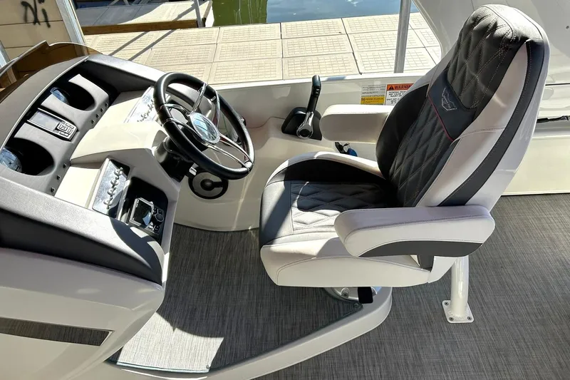 Slide: The Image of Captain's chair and helm of 2021 Bennington 25 RXSBA boat, featuring modern controls. - 5