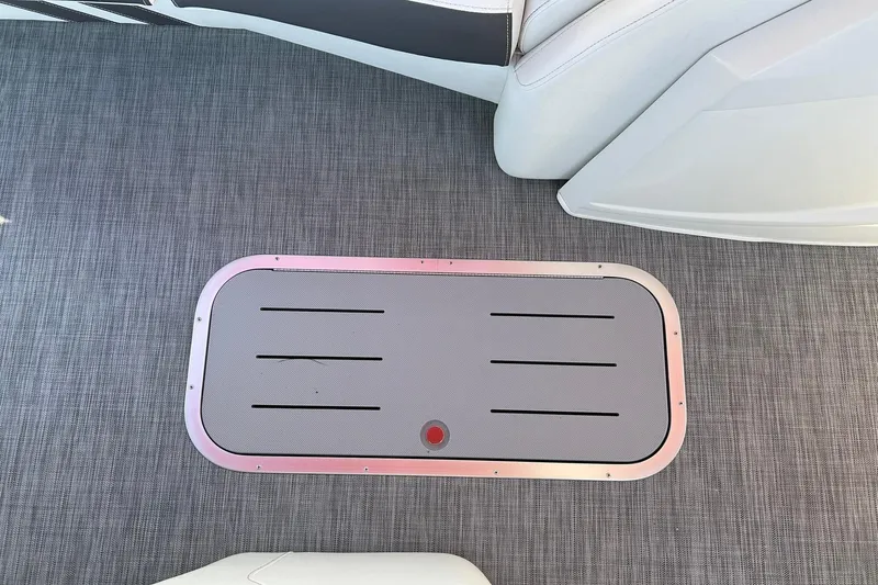 Slide: The Image of 2021 Bennington 25 RXSBA boat interior with sleek flooring and storage compartment. - 55
