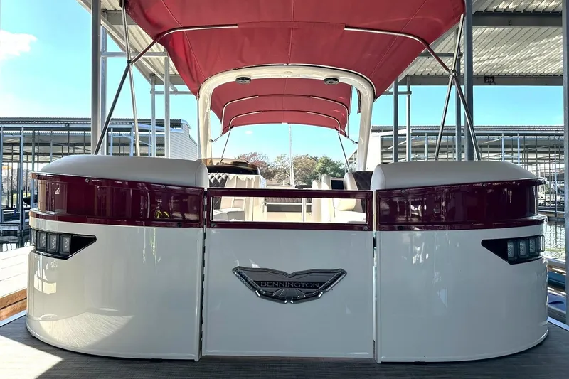 Slide: The Image of 2021 Bennington 25 RXSBA pontoon boat with red canopy docked in marina. - 56