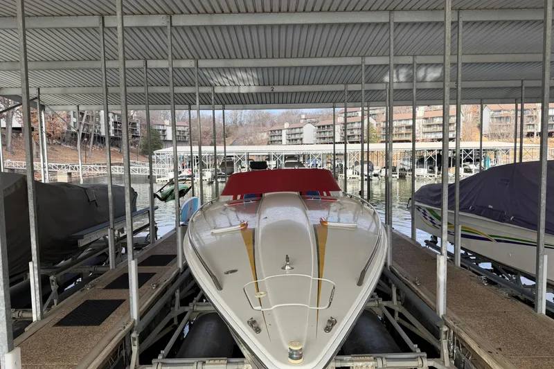 Slide: The Image of 2000 Formula 353 FASTech boat docked in a covered marina. - 12
