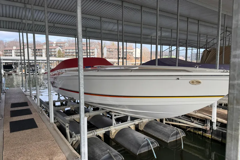 Slide: The Image of 2000 Formula 353 FASTech boat docked in a covered marina. - 14