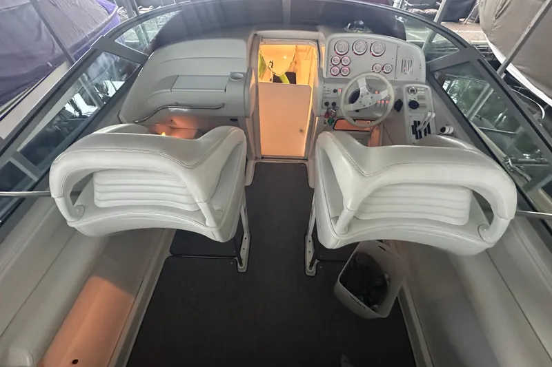 Slide: The Image of 2000 Formula 353 FASTech boat interior with white seating and dashboard controls. - 16