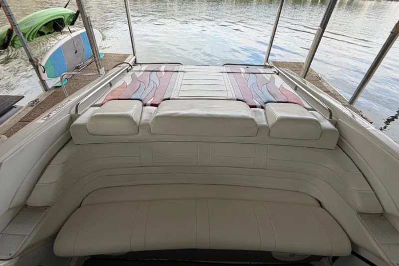 Slide: The Image of 2000 Formula 353 FASTech boat interior with white seating and colorful accents, docked by the water. - 17