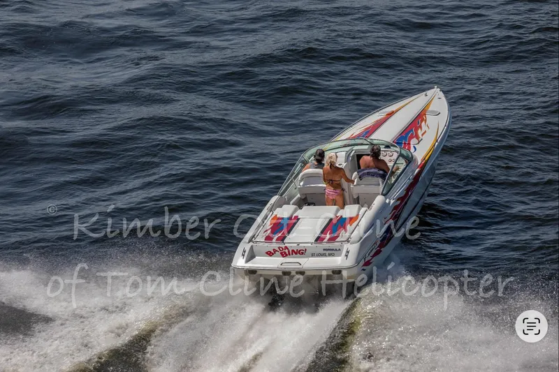 Slide: The Image of 2000 Formula 353 FASTech speedboat cruising on open water, vibrant graphics, aerial view. - 2